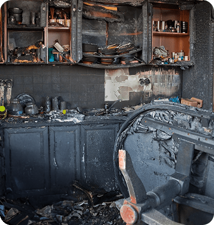 A kitchen that has been burned and is in need of repair.