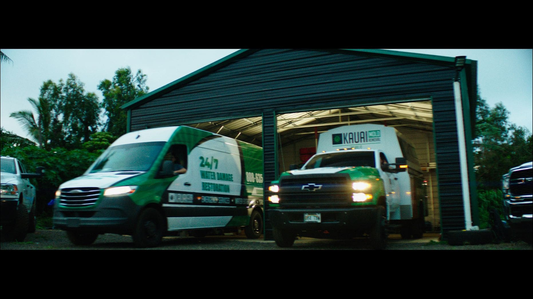 A couple of trucks parked in front of a building.