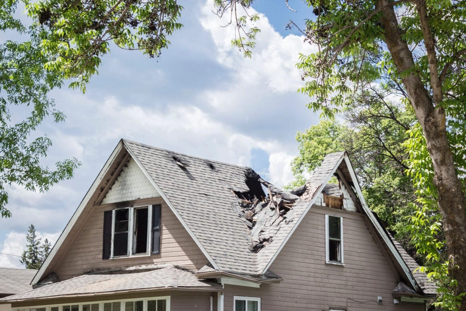 A house with a roof that has been torn off.