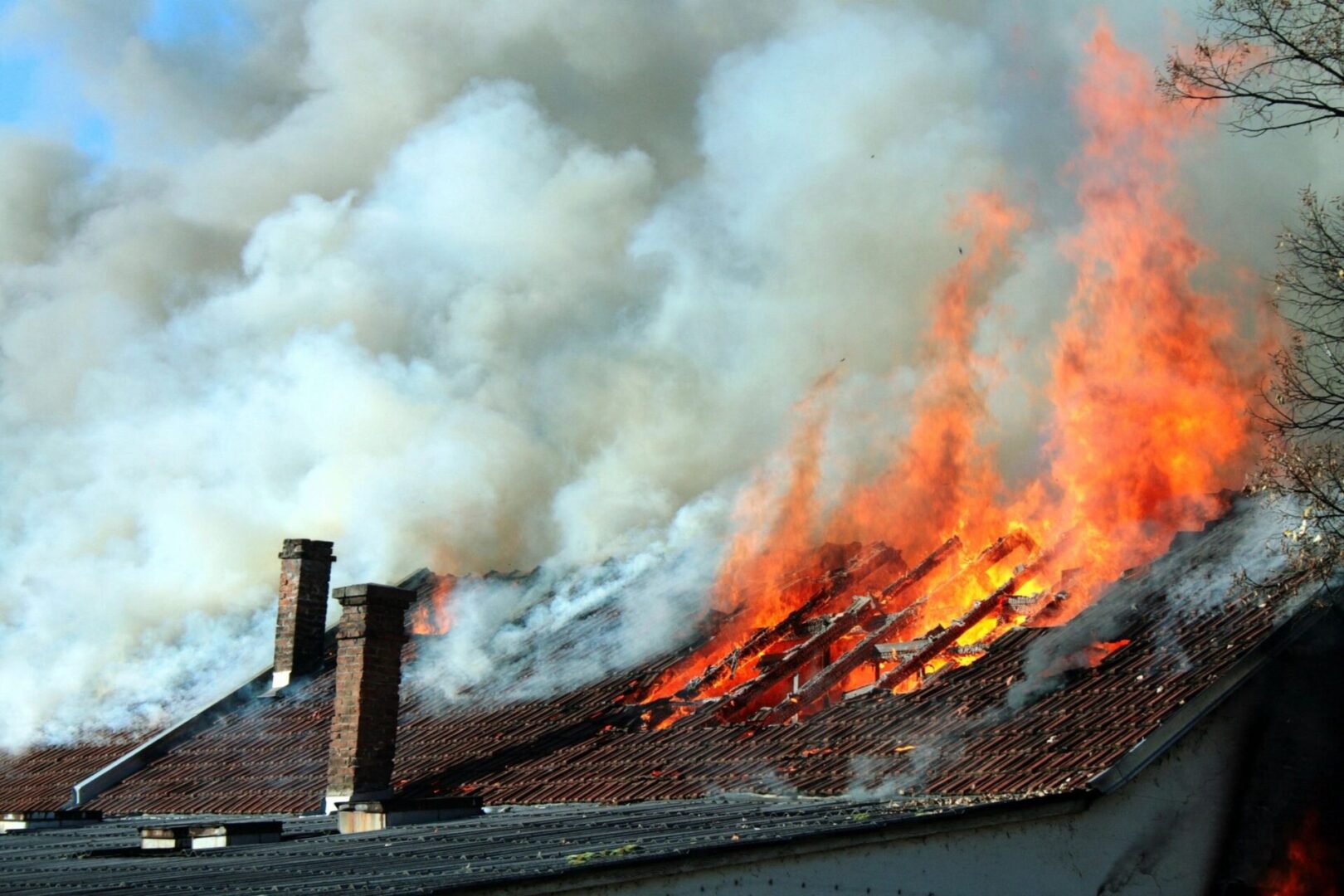 A fire burning on top of a building.